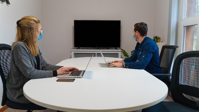 The man in blue shirt using macbook air
